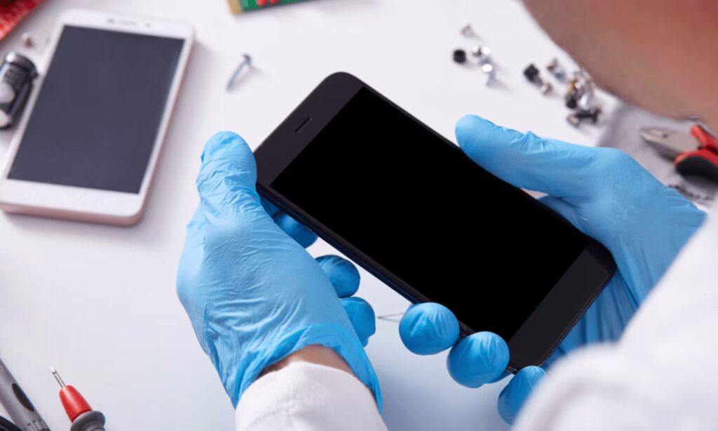Person holding an iPhone in their hands for repair