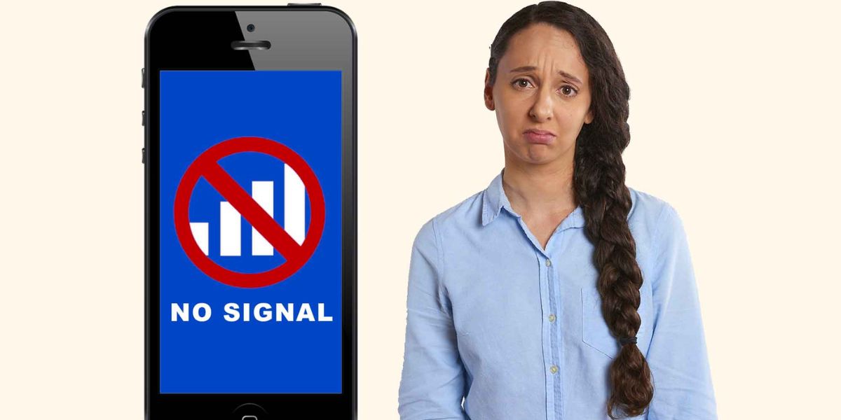 Disappointed woman standing next to a smartphone displaying a blue screen with a "NO SIGNAL" warning and a red circle