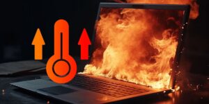 An open laptop with its screen engulfed in fire, next to an orange and red thermometer icon